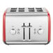 A silver and red KitchenAid four slice toaster with dials and buttons.