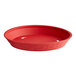 A red round plastic platter with a white background.