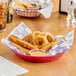 A red Choice plastic diner platter with fried food in it.