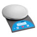An AvaWeigh digital portion scale with a round blue display.