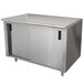 A stainless steel cabinet with doors on a stainless steel work table.