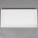 A white rectangular American Metalcraft flat melamine platter on a gray surface.