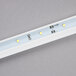 An Avantco LED light bulb with three white lights.