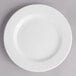 A white Villeroy & Boch porcelain plate with a white rim on a gray surface.