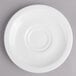 A white porcelain saucer with a circular ring on a gray surface.