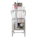 The stainless steel water tank of a Jackson TempStar high temperature door type dish washer with a hose attached.