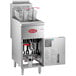 An Avantco natural gas floor fryer with an open door and a basket inside.