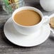 A Villeroy & Boch white porcelain cup of coffee on a saucer.