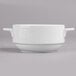 A close-up of a white Villeroy & Boch porcelain soup bowl with two handles.