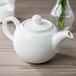 A close-up of a Villeroy & Boch white porcelain teapot on a table.