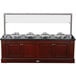A Bon Chef wood buffet with four chafers and four induction warmers on a counter.
