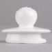 A white porcelain coffeepot lid with a round base.