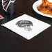 A Creative Converting Atlanta Falcons luncheon napkin on a table.