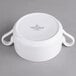 A white porcelain soup bowl with two handles.