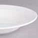 A Villeroy & Boch white porcelain rim deep soup plate on a gray surface.