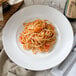 A white Villeroy & Boch porcelain plate with pasta and shrimp on it.