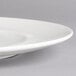 A close-up of a white Villeroy & Boch porcelain flat plate with a small rim.