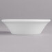 A Villeroy & Boch white porcelain bowl on a gray surface.