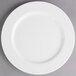 A white Villeroy & Boch porcelain flat plate with a white rim on a gray surface.