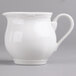 A white porcelain creamer with a white handle.