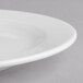 A close-up of a Villeroy & Boch white porcelain flat plate with a rim.