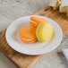 A Villeroy & Boch white porcelain plate with two macarons on it.