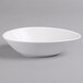 A Villeroy & Boch white porcelain oval deep bowl on a gray surface.