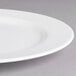 A close-up of a white Villeroy & Boch porcelain flat plate with a white rim.