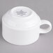 A white porcelain stackable cup with a handle.