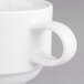 A close-up of a Villeroy & Boch white porcelain coffee mug with a handle.