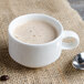 A white Villeroy & Boch porcelain cup of coffee with a spoon.