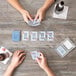 A group of people playing cards with Hoyle Waterproof Playing Cards.