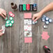 A group of people playing poker on a table with Bicycle Premium poker chips.