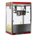 A red Paragon Theater Pop popcorn machine with a white cover.