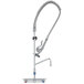 A T&S stainless steel wall mounted pre-rinse faucet with hose.