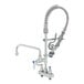 A T&S deck mounted pre-rinse faucet with hose and sprayer.