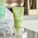 A small green Dial Restore conditioner bottle with green text.