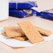 A stack of Nabisco Honey Maid Honey Graham crackers on a white napkin.