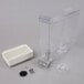 A clear plastic container with a white rectangular container and a white rectangular container.