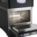 A black and silver Merrychef eikon e2s countertop oven on a tray in a school kitchen.
