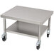 A silver stainless steel mobile mixer table with wheels.