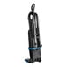 A black upright bagged vacuum cleaner with a blue accent, featuring a coiled cord and hose attachment.