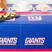 A table with a New York Giants tablecloth on it.