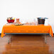 A table with a Cincinnati Bengals tablecloth and food on it.