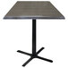A Holland Bar Stool charcoal table with a square black top on a black cross base.