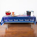 A table with a Tennessee Titans tablecloth and food on it.