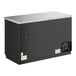 A black True back bar refrigerator with glass doors open.