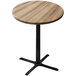 A round wooden Holland Bar Table with a black cross base.