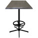 A Holland Bar Stool charcoal square outdoor bar table with a metal base.