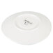 A white porcelain saucer with a black pebble design.
